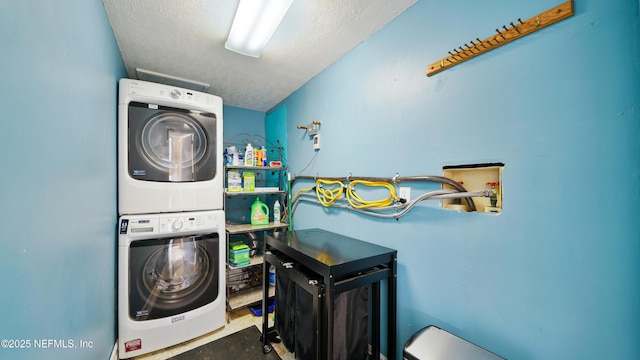 washroom featuring a textured ceiling, laundry area, and stacked washer / dryer