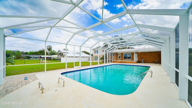 pool featuring a patio, a lawn, and glass enclosure