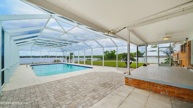 view of swimming pool with a fenced in pool, a water view, a ceiling fan, a patio area, and a lanai