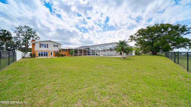 view of yard with a lanai and a fenced backyard