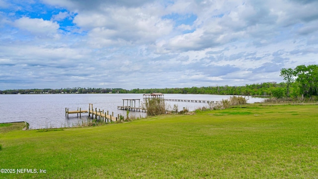 view of dock featuring a yard and a water view