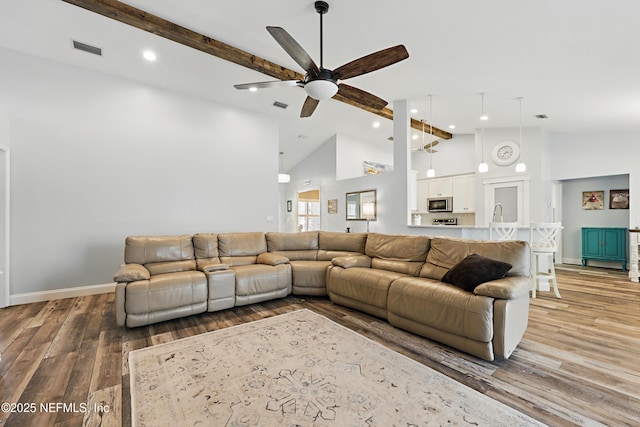 living room with high vaulted ceiling, visible vents, and light wood-style flooring