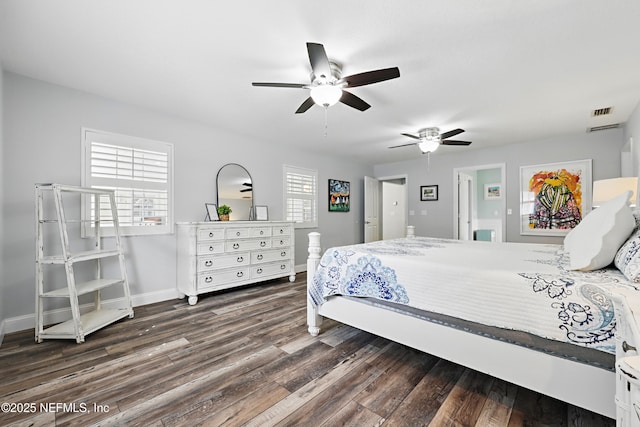 bedroom featuring baseboards, visible vents, ceiling fan, and wood finished floors