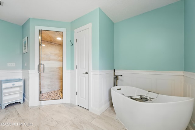 full bath featuring a stall shower, visible vents, a wainscoted wall, marble finish floor, and a freestanding bath