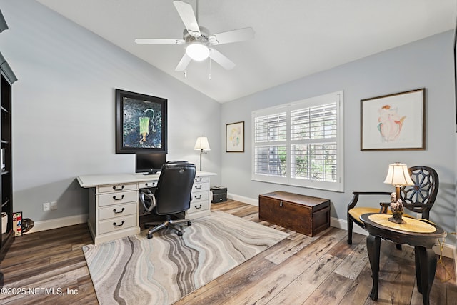 office area featuring vaulted ceiling, ceiling fan, wood finished floors, and baseboards