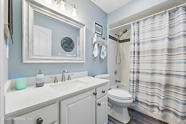 bathroom featuring shower / tub combo with curtain, vanity, toilet, and wood finished floors