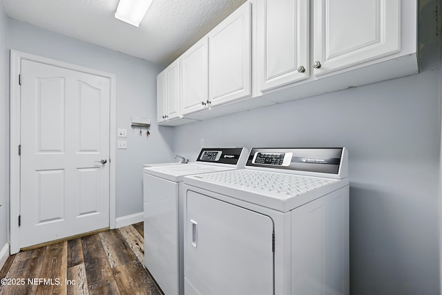 laundry room featuring dark wood finished floors, cabinet space, independent washer and dryer, and baseboards