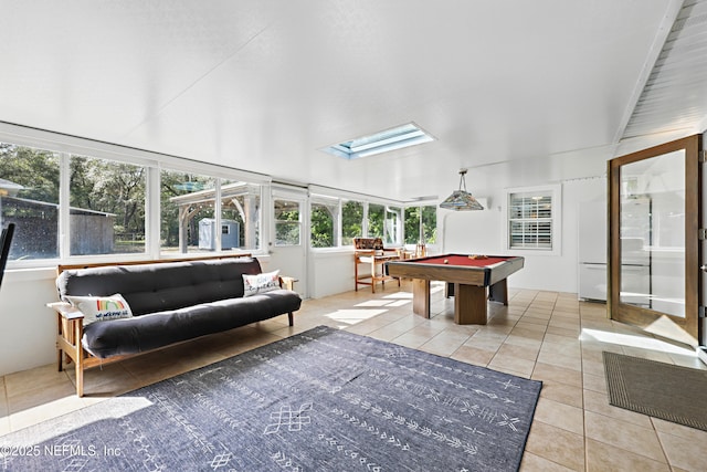 recreation room with a skylight, pool table, and tile patterned floors