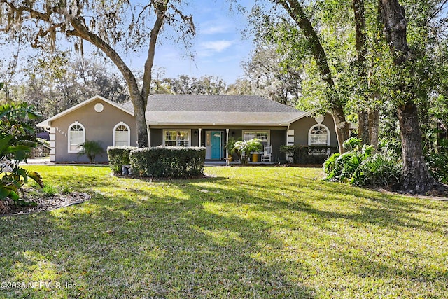 ranch-style house with a front lawn and stucco siding