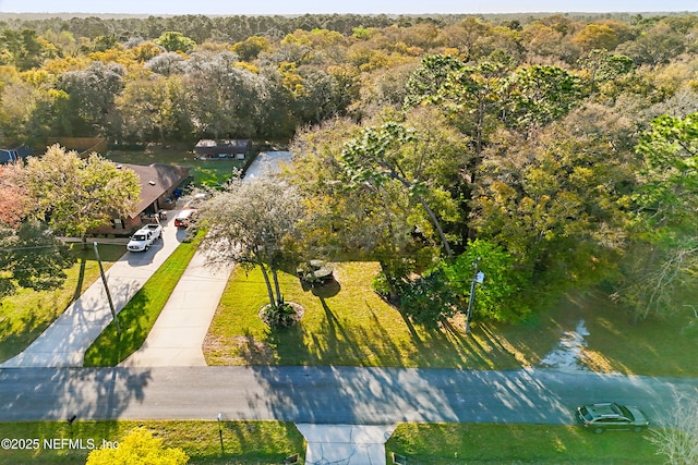 bird's eye view with a wooded view