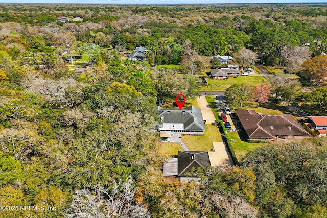 drone / aerial view with a residential view and a view of trees