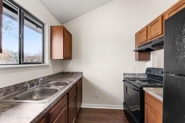 kitchen featuring dark wood-style flooring, a sink, black appliances, under cabinet range hood, and baseboards