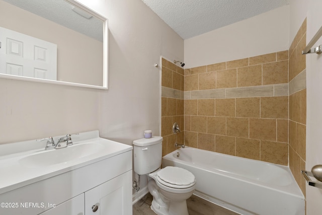 bathroom with a textured ceiling, shower / washtub combination, vanity, and toilet