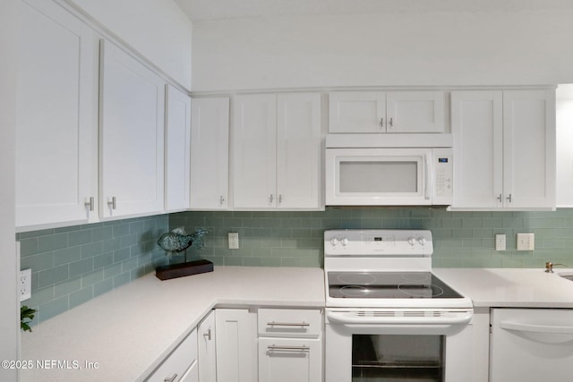 kitchen featuring tasteful backsplash, light countertops, white appliances, and white cabinets