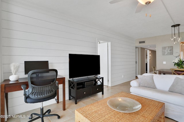 living area featuring light tile patterned floors, visible vents, and a ceiling fan