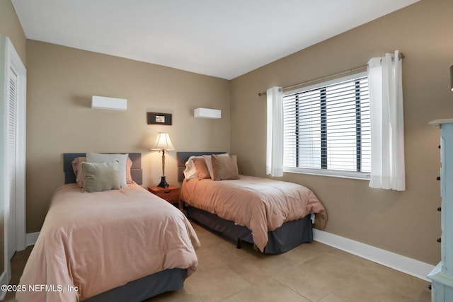 bedroom with tile patterned flooring and baseboards