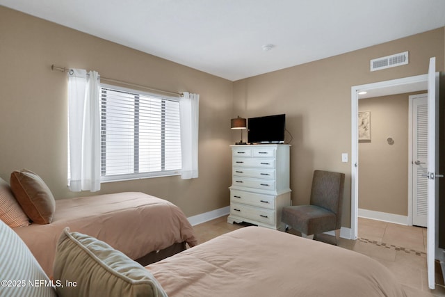 tiled bedroom featuring visible vents and baseboards