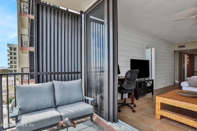 living room with visible vents and wooden walls