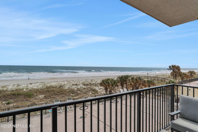 balcony with a beach view and a water view