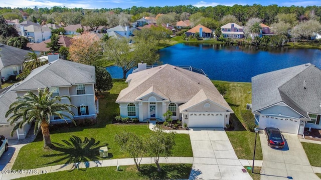 drone / aerial view featuring a water view and a residential view