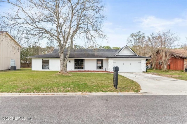 ranch-style house featuring a garage, a front yard, cooling unit, and driveway