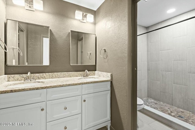 2204 Chablis Ct W, Orange Park, FL 32073 - bathroom featuring a tile shower, a textured wall, and a sink