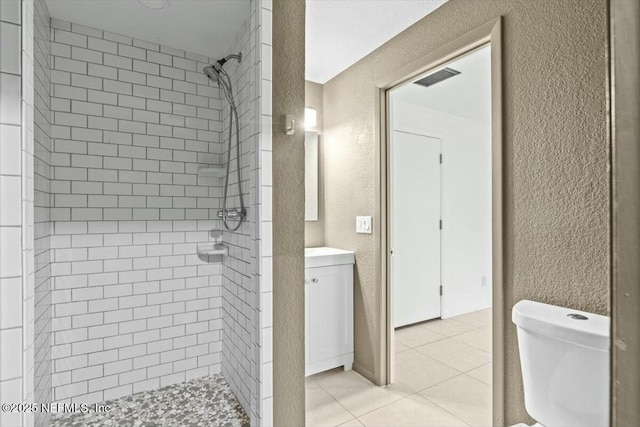 2204 Chablis Ct W, Orange Park, FL 32073 - full bathroom featuring a textured wall, toilet, tile patterned floors, a tile shower, and vanity