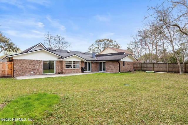 2204 Chablis Ct W, Orange Park, FL 32073 - back of property featuring a fenced backyard, a yard, and brick siding