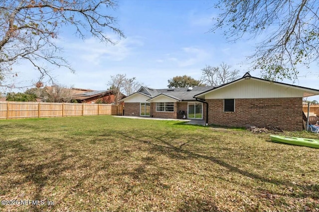 2204 Chablis Ct W, Orange Park, FL 32073 - back of property featuring a yard, fence, and brick siding