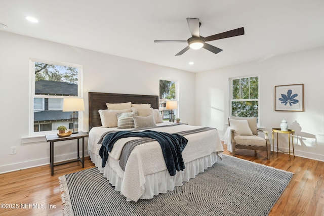 bedroom with a ceiling fan, recessed lighting, light wood-style floors, and baseboards