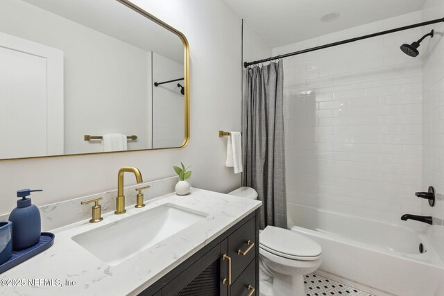 full bath with shower / bath combo with shower curtain, toilet, and vanity