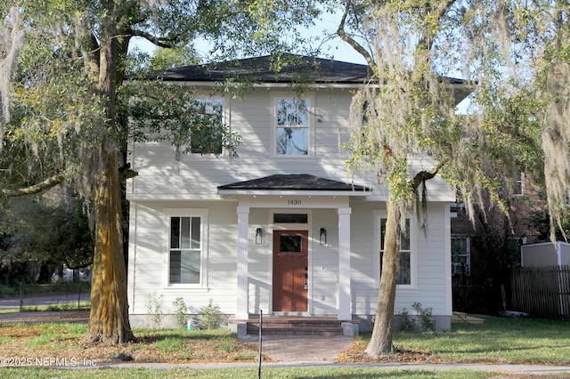 view of front facade featuring fence