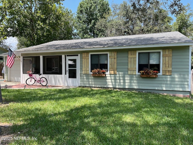 ranch-style home featuring a garage and a front lawn