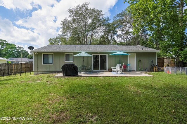 back of property featuring a patio, fence, and a lawn