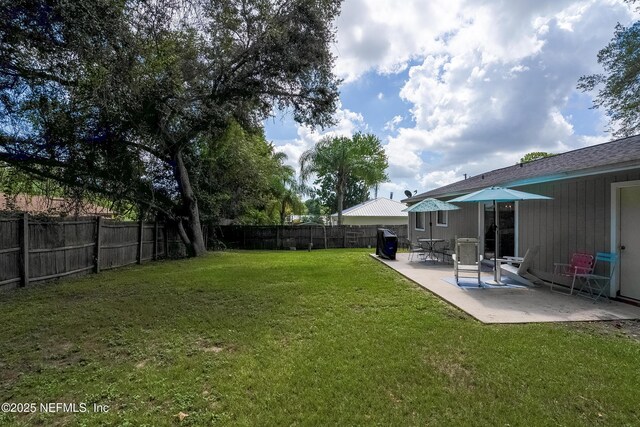 view of yard featuring a patio and a fenced backyard