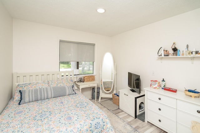 bedroom with light wood finished floors