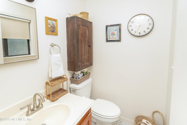 half bathroom featuring toilet and vanity