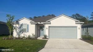 ranch-style house featuring a front yard, a garage, and driveway