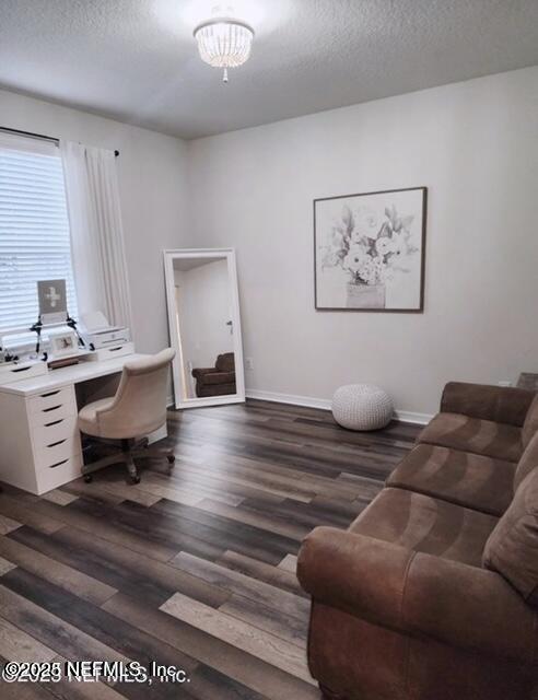 office area with wood finished floors, baseboards, and a textured ceiling