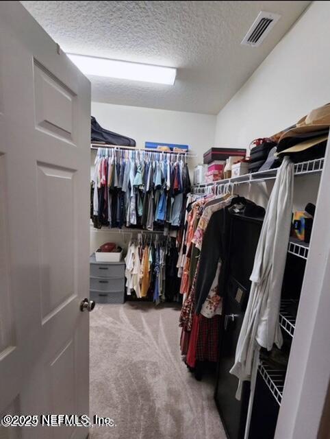 spacious closet with carpet and visible vents