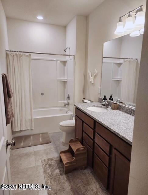 bathroom with vanity, toilet, and shower / bathtub combination with curtain