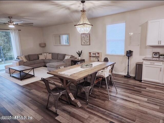 dining space with a wealth of natural light, baseboards, and dark wood-style floors