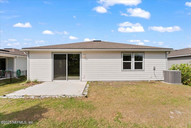 rear view of house with a patio, central AC, a yard, and fence