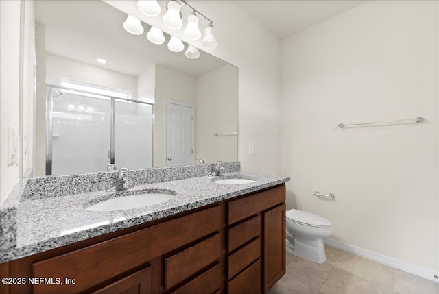 bathroom with double vanity, toilet, a sink, and a stall shower