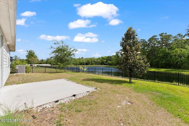 view of yard with central air condition unit, a patio, a water view, and a fenced backyard