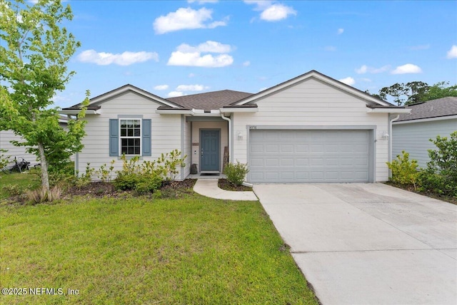 ranch-style home featuring an attached garage, concrete driveway, and a front yard