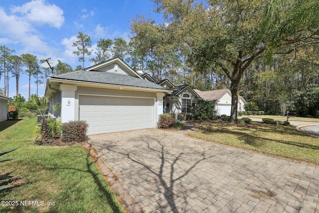 ranch-style house with a garage, a shingled roof, decorative driveway, stucco siding, and a front lawn