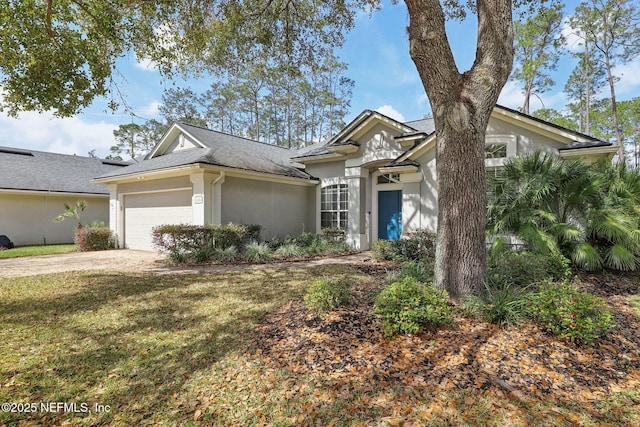 view of front facade featuring an attached garage, a front yard, concrete driveway, and stucco siding