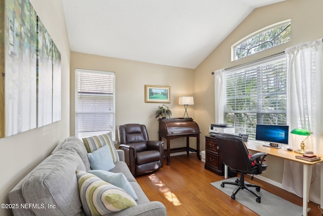 home office with baseboards, vaulted ceiling, and wood finished floors