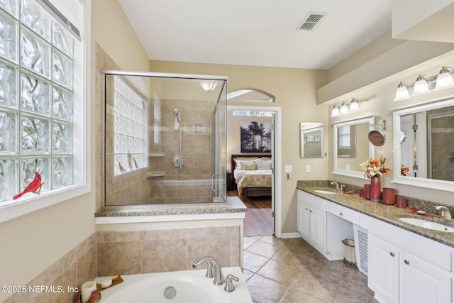 ensuite bathroom with visible vents, a sink, a shower stall, and ensuite bathroom